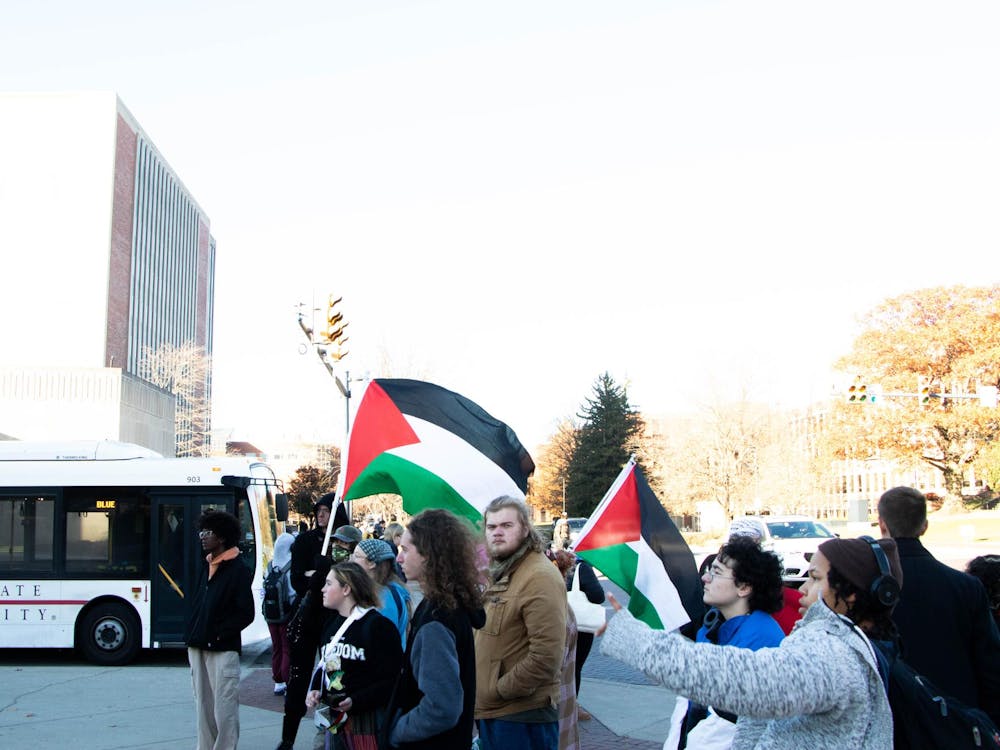 Protesters stand at the Scramble Light raising awareness for the hunger strike Nov.12. Will Baker, DN