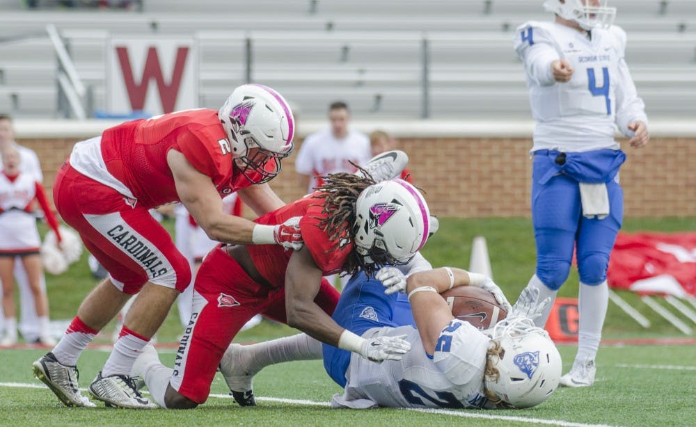 Junior linebacker Zack Ryan and junior safety Aaron Taylor tackle a Georgia State player during the game on Oct. 17at Scheumann Stadium. DN PHOTO BREANNA DAUGHERTY