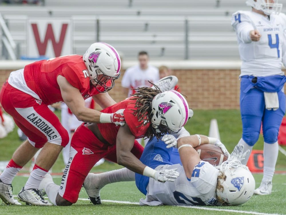Junior linebacker Zack Ryan and junior safety Aaron Taylor tackle a Georgia State player during the game on Oct. 17at Scheumann Stadium. DN PHOTO BREANNA DAUGHERTY
