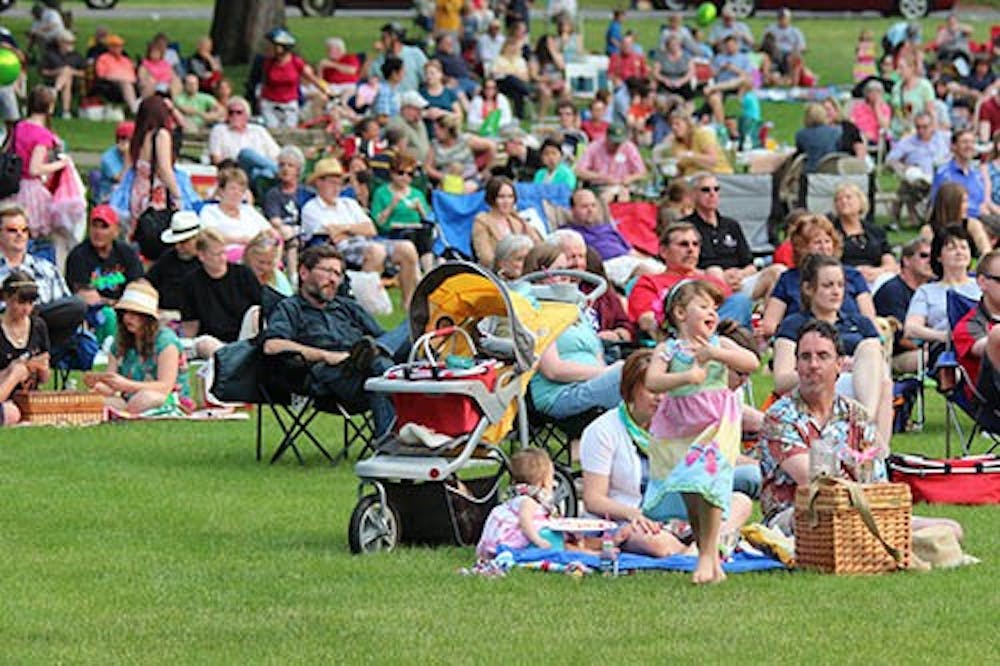 Among the crowd of people a girl twirls in her picnic dress at the Festival on the Green. The annual event draws hundreds of people to the campus. DN PHOTO KRYSTAL BYERS