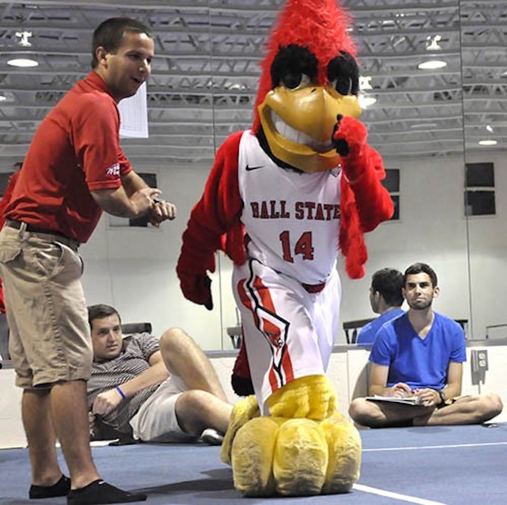 A student tries out Charlie Cardinal's outfit Friday night in the Student Recreation and Wellness Center. The tryout included a test of speed. DN PHOTO Sicong Xing