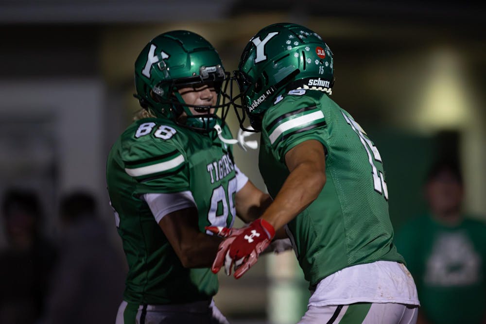 Senior Ephram Daugherty celebrates after scoring a touchdown against New Palestine Sept. 6 at Yorktown High School. Titus Slaughter, DN