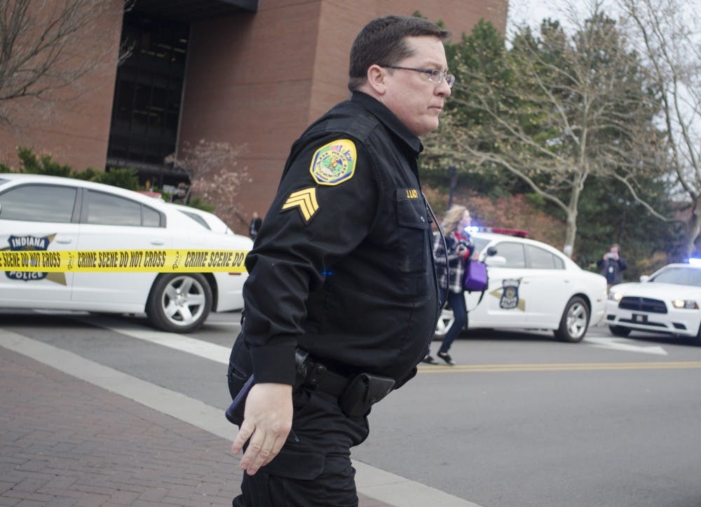 Muncie Police Officer J. Lacy helps secure the Student Recreation and Wellness Center after a report of an armed assailant in the building. DN PHOTO COREY OHLENKAMP