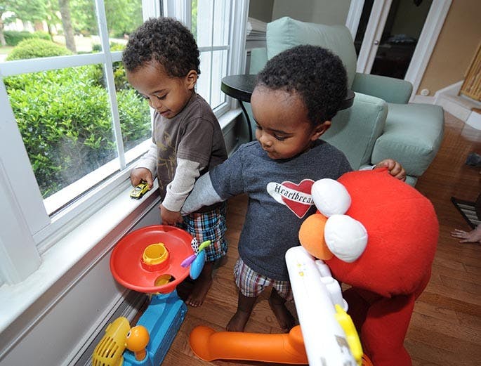 Asher Howard, 23 months, left, plays with his brother, Samuel Howard inside their Powder Springs, Georgia home, April 6, 2012. When Kindred Howard and his wife, Meredith Howard, adopted their infant sons from Ethiopia in 2010, the consensus was that they were lucky to be alive. But less than 14 months later, the twins are healthy, happy, and on a movie set starring with Jennifer Lopez in the upcoming movie, &quot;What to Expect When You&apos;re Expecting&quot; due out in May 2012. (Johnny Crawford/Atlanta Journal-Constitution/MCT)