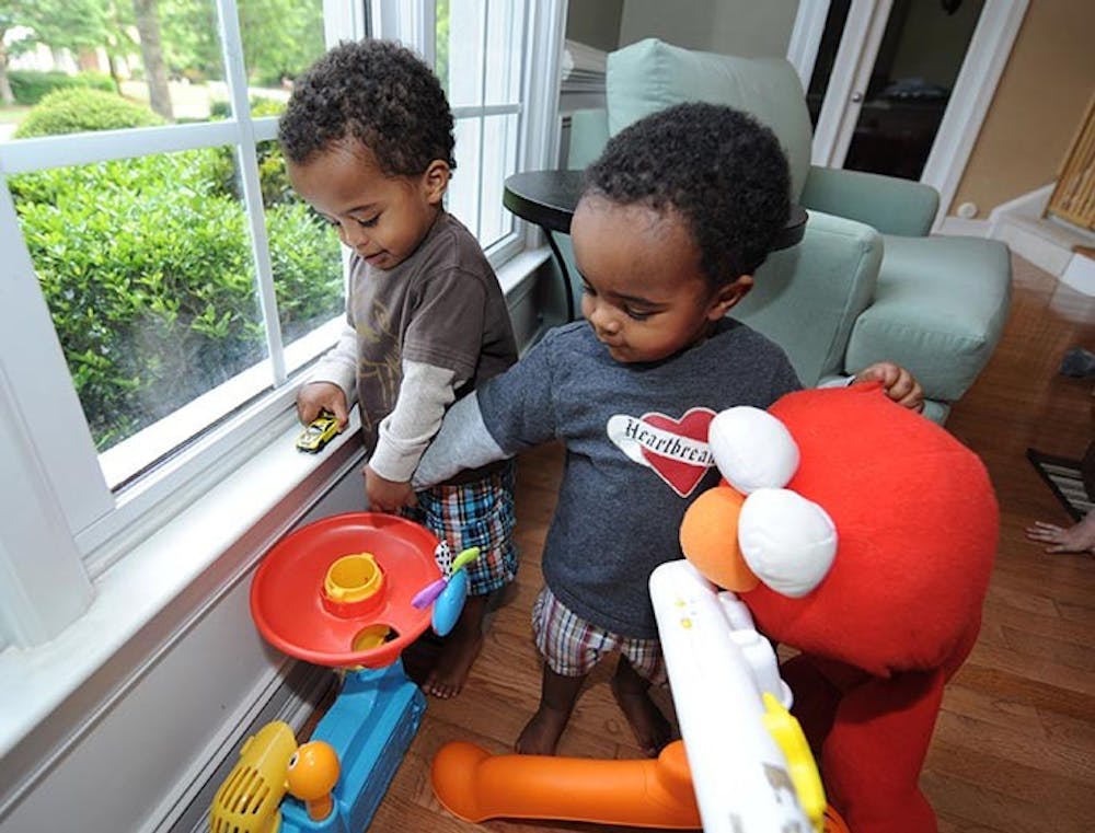 Asher Howard, 23 months, left, plays with his brother, Samuel Howard inside their Powder Springs, Georgia home, April 6, 2012. When Kindred Howard and his wife, Meredith Howard, adopted their infant sons from Ethiopia in 2010, the consensus was that they were lucky to be alive. But less than 14 months later, the twins are healthy, happy, and on a movie set starring with Jennifer Lopez in the upcoming movie, &quot;What to Expect When You&apos;re Expecting&quot; due out in May 2012. (Johnny Crawford/Atlanta Journal-Constitution/MCT)