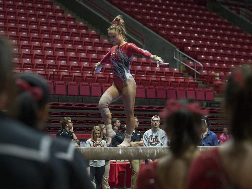 Members of the gymnastics team watch teammate senior Sarah Ebeyer perform her routine on the beam during the meet against Kentucky Jan. 29 at John E. Worthen Arena. Breanna Daugherty // DN