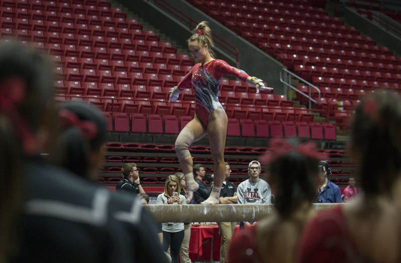 Members of the gymnastics team watch teammate senior Sarah Ebeyer perform her routine on the beam during the meet against Kentucky Jan. 29 at John E. Worthen Arena. Breanna Daugherty // DN