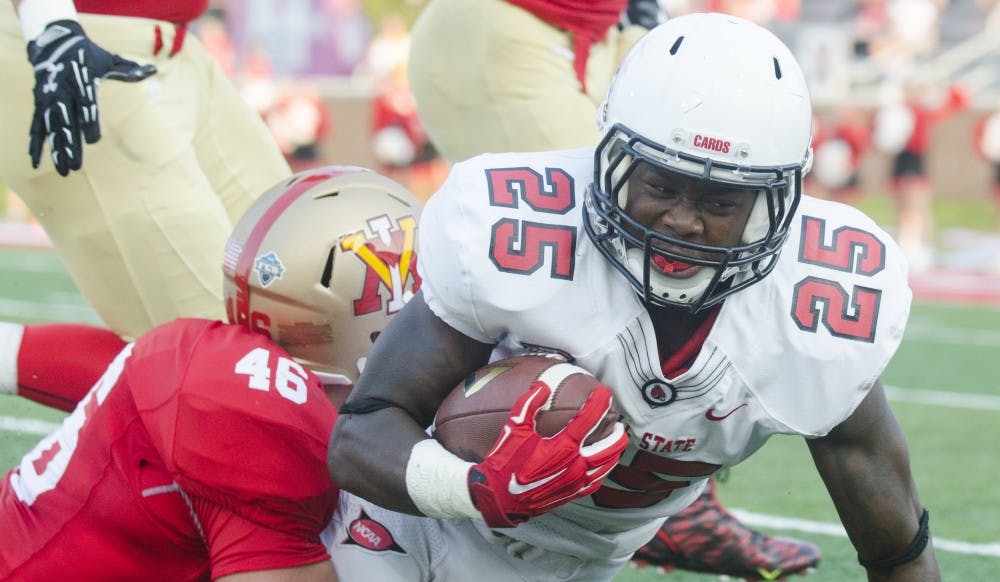 Sophomore running back Darian Green gets tackled during the game against Virginia Military Institute on Sept. 3 at Scheumann Stadium. DN PHOTO BREANNA DAUGHERTY