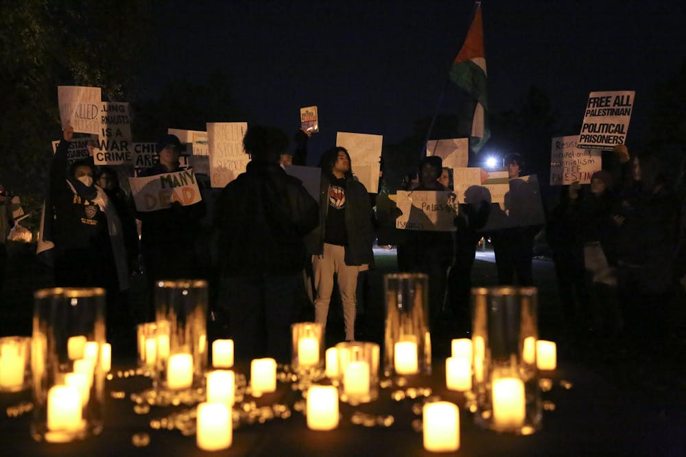 Peaceful protestors listen as their member gives a speech calling for the freedom of Palestine at a peace vigil Nov. 1 at Beneficence Statue. Andrew Berger, DN