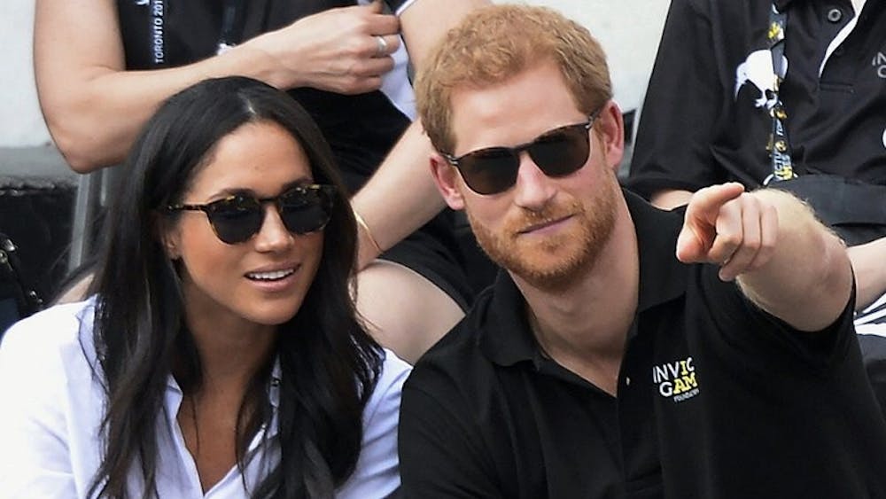 In this Monday, Sept. 25, 2017 file photo, Britain's Prince Harry and his girlfriend Meghan Markle attend the wheelchair tennis competition during the Invictus Games in Toronto. Palace officials announced Monday Nov. 26, 2017, Prince Harry and Meghan Markle are engaged, and will marry in the spring. Associated Press