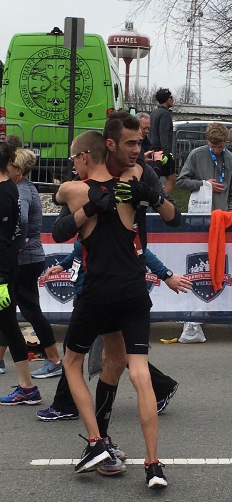 Junior Chris Meyer embraces junior John Brown after the two qualified for the Boston Marathon at the Carmel Marathon on March 31, 2018 in Carmel, Indiana. Junior Katie Fedoronko qualified alongside Meyer and Brown for the Boston Marathon. Chris Meyer, Photo Provided&nbsp;