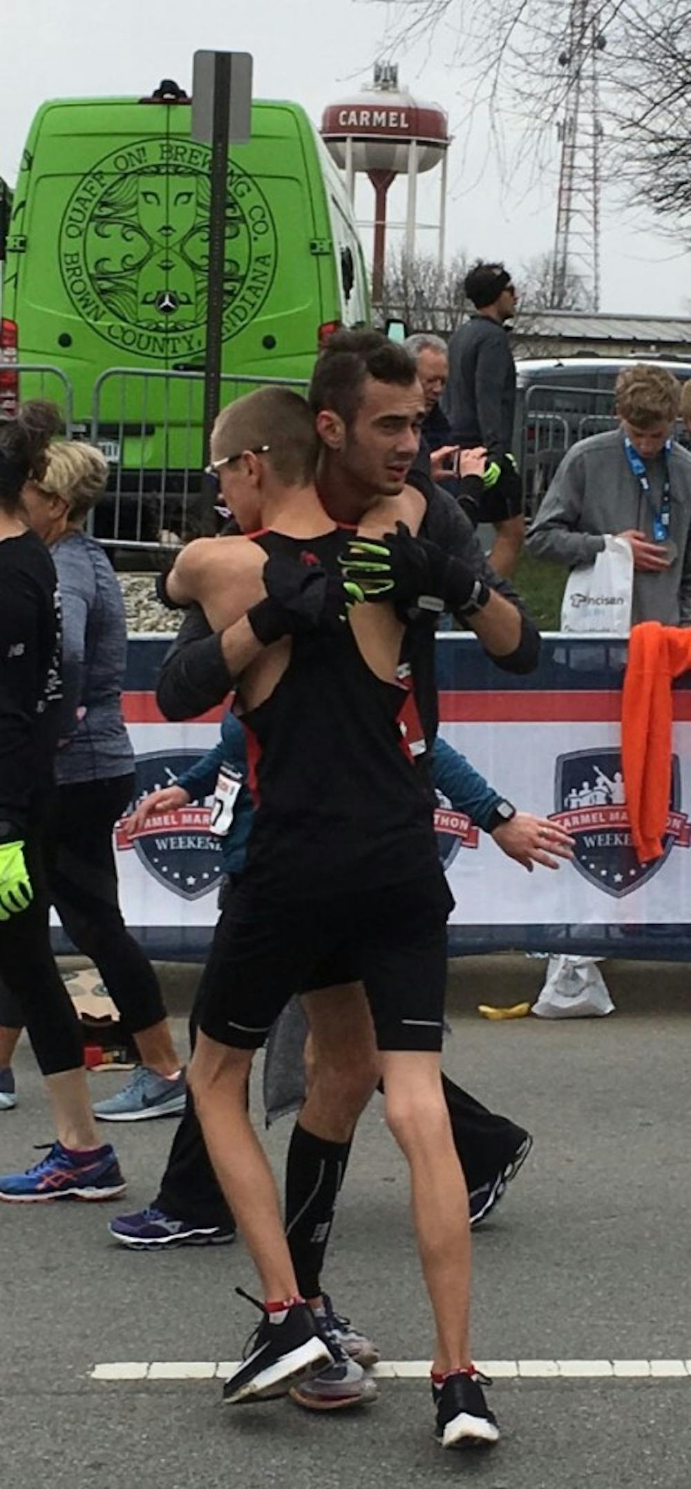 <p>Junior Chris Meyer embraces junior John Brown after the two qualified for the Boston Marathon at the Carmel Marathon on March 31, 2018 in Carmel, Indiana. Junior Katie Fedoronko qualified alongside Meyer and Brown for the Boston Marathon.<strong> Chris Meyer, Photo Provided&nbsp;</strong></p>