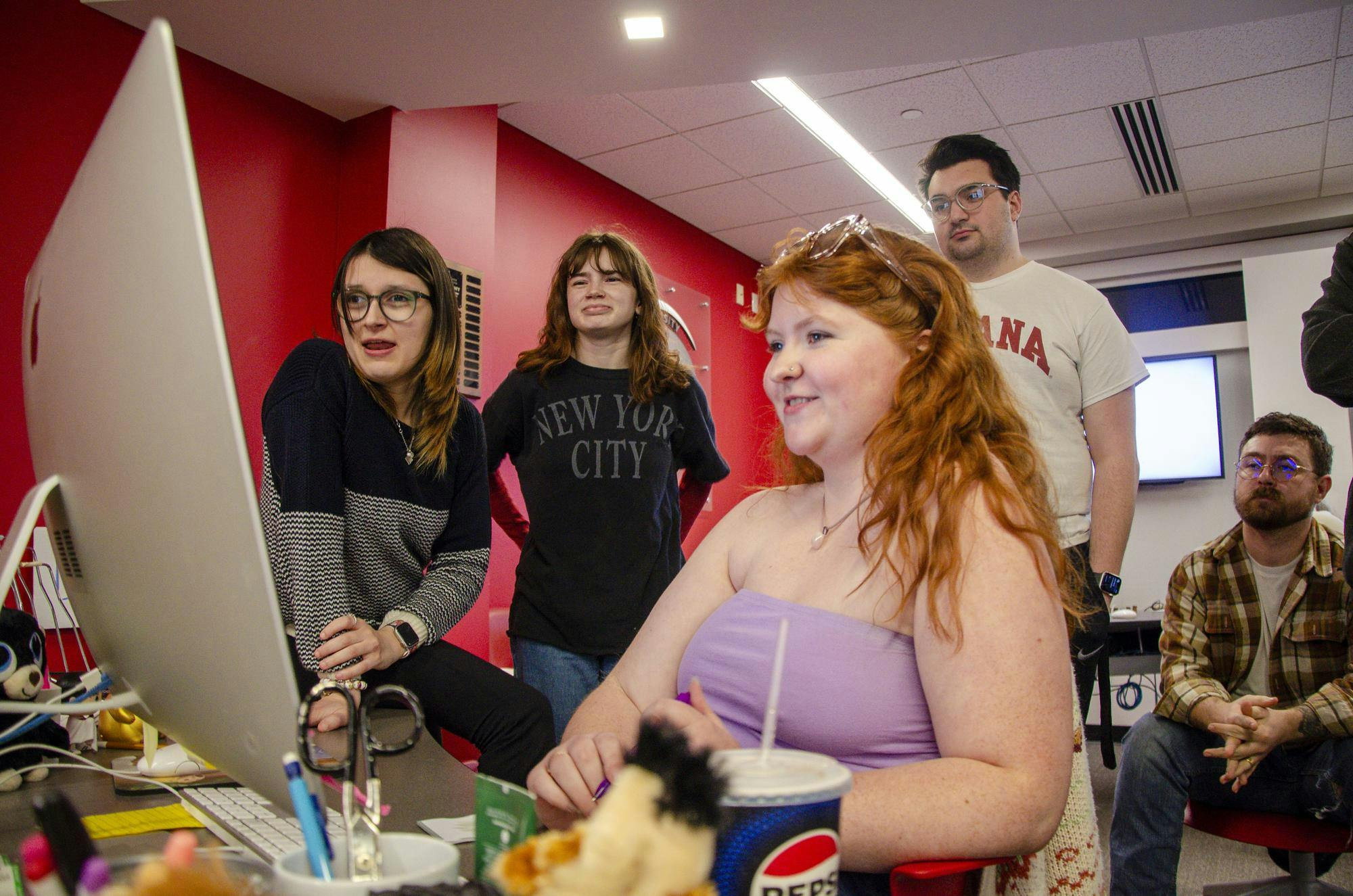 Ball State Daily News staff look at pages during Print Night.