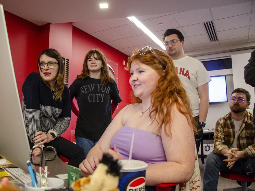 Ball State Daily News staff look at pages during Print Night.