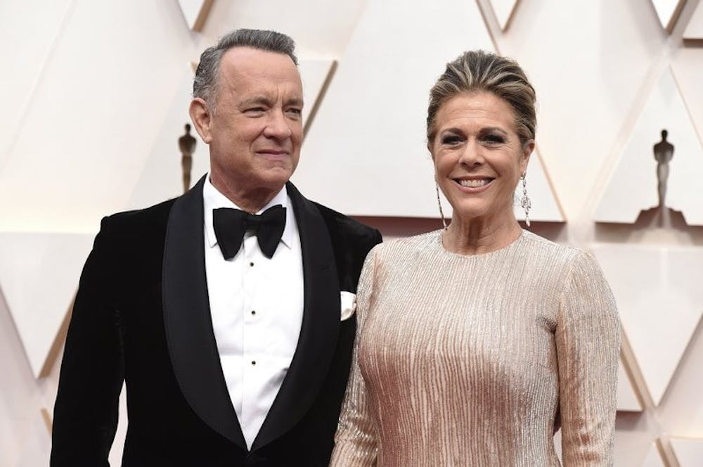 In this Feb. 9, 2020 photo, Tom Hanks and Rita Wilson arrive at the Oscars at the Dolby Theatre in Los Angeles. The couple have tested positive for the coronavirus, the actor said in a statement Wednesday, March 11. The 63-year-old actor said they will be "tested, observed and isolated for as long as public health and safety requires." (Photo by Jordan Strauss/Invision/AP, File)