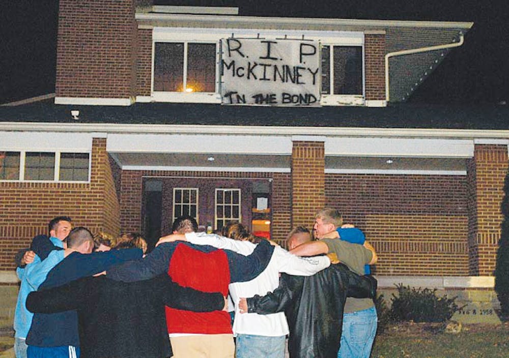 Members of Delta Chi fraternity sing a chant after hanging a banner ever their old house in memory of member Michael McKinney, who died November 7, 2003. Some fraternity members still call McKinney