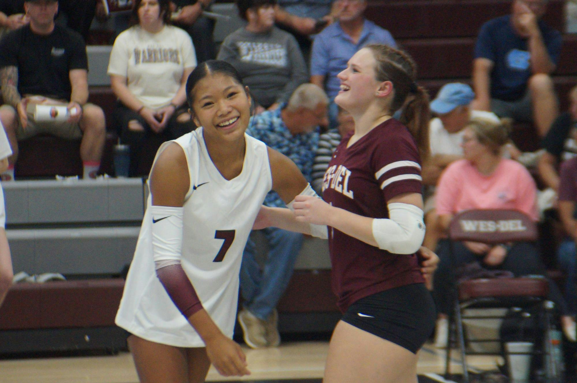 Freshman Joy Toney, 7, and Senior KyLynn New, 1, hug after another point scored. Their next game will be at the Eastbrook Invitational Sept. 20 at 9 a.m. PHOTO BY NICK ROARK

