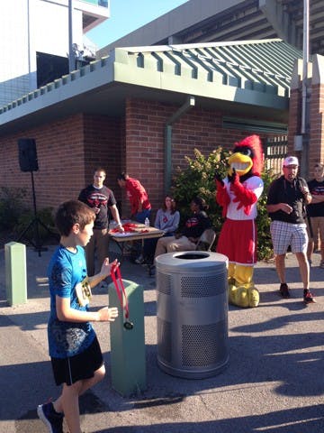 Charlie Cardinal and his crew give out medals for Chase Charlie and Mile Mania on Saturday morning. Chase Charlie had about 100 more participants this year than last, officials said.