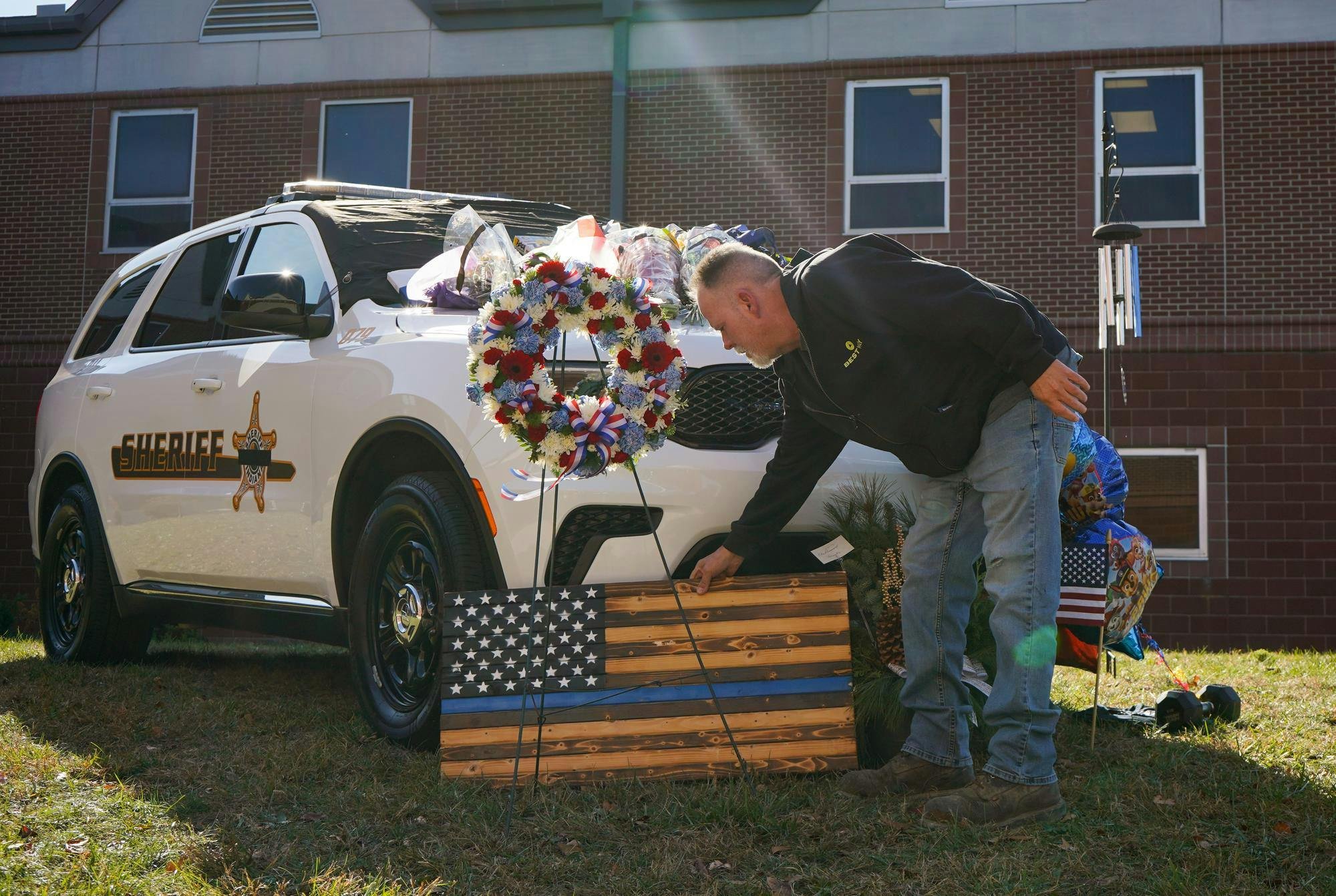 Members of the community stop by to honor the memory of Corporal Blake Reynolds Nov. 13 at Delaware County Sheriff's Office. Reynolds was stuck and killed Wednesday morning while helping a semi on the side of the road. Isabella Kemper, DN
