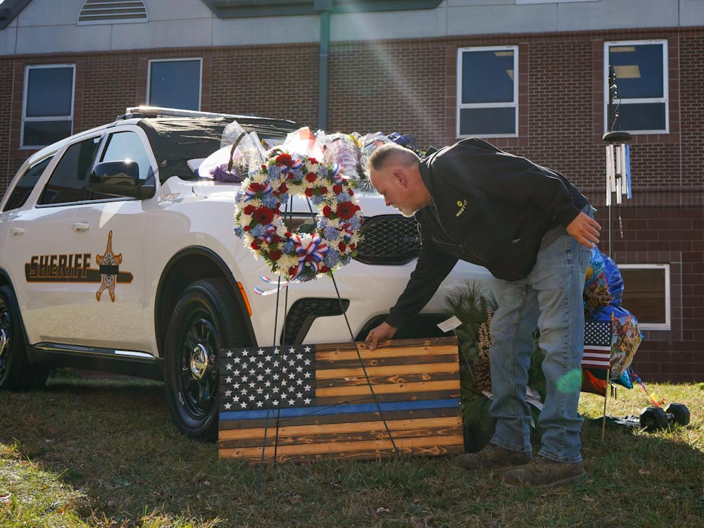 Members of the community stop by to honor the memory of Corporal Blake Reynolds Nov. 13 at Delaware County Sheriff's Office. Reynolds was stuck and killed Wednesday morning while helping a semi on the side of the road. Isabella Kemper, DN