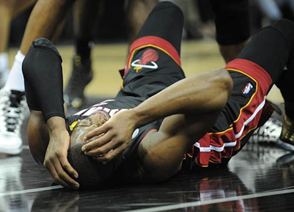 Dwyane Wade of the Miami Heat holds his head after hitting the floor during Game 5 of the NBA Finals against the San Antonio Spurs. The Heat lost the game 114-104 to the Spurs. MCT PHOTO