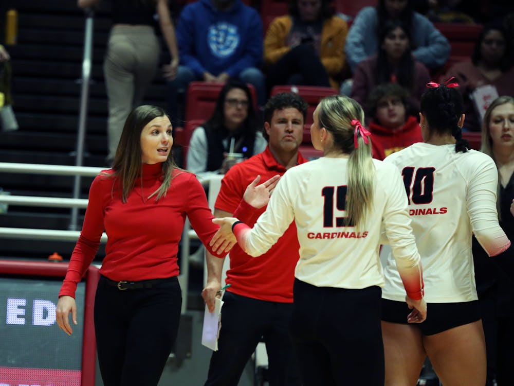 Women's volleyball coach Kelli Miller Phillips gives junior setter Megan Wielonski a high-five during a time out agianst Toledo Oct. 17 at Worthen Arena. Ball State won 3-0 against Toledo. Mya Cataline, DN