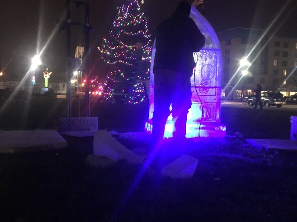 Indiana Ice Studio founder Stephen Koch had a crowd of about 40 people gathered around two watch him sculpt. Koch transformed a rectangular block of ice to a holiday moment with the&nbsp;"DWNTWN" logo at the base.&nbsp;DN PHOTO CASEY SMITH