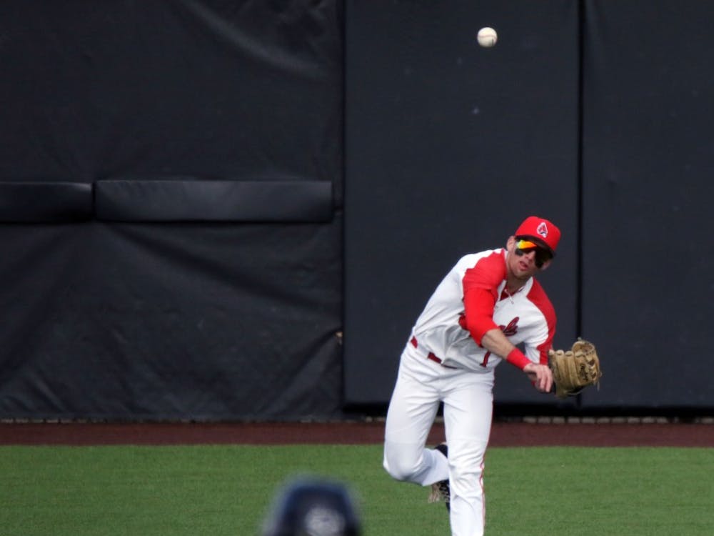 Ball State junior center fielder Aaron Simpson throws the ball in field as Purdue sophomore second baseman Tyler Powers hesitates between second and third during the Cardinals' game against the Boilermakers March 19, 2019 at Ball Diamond at First Merchants Ballpark Complex in Muncie, IN. Ball State's 6 to 0 win over Purdue gives them a 11-9 record. Paige Grider, DN