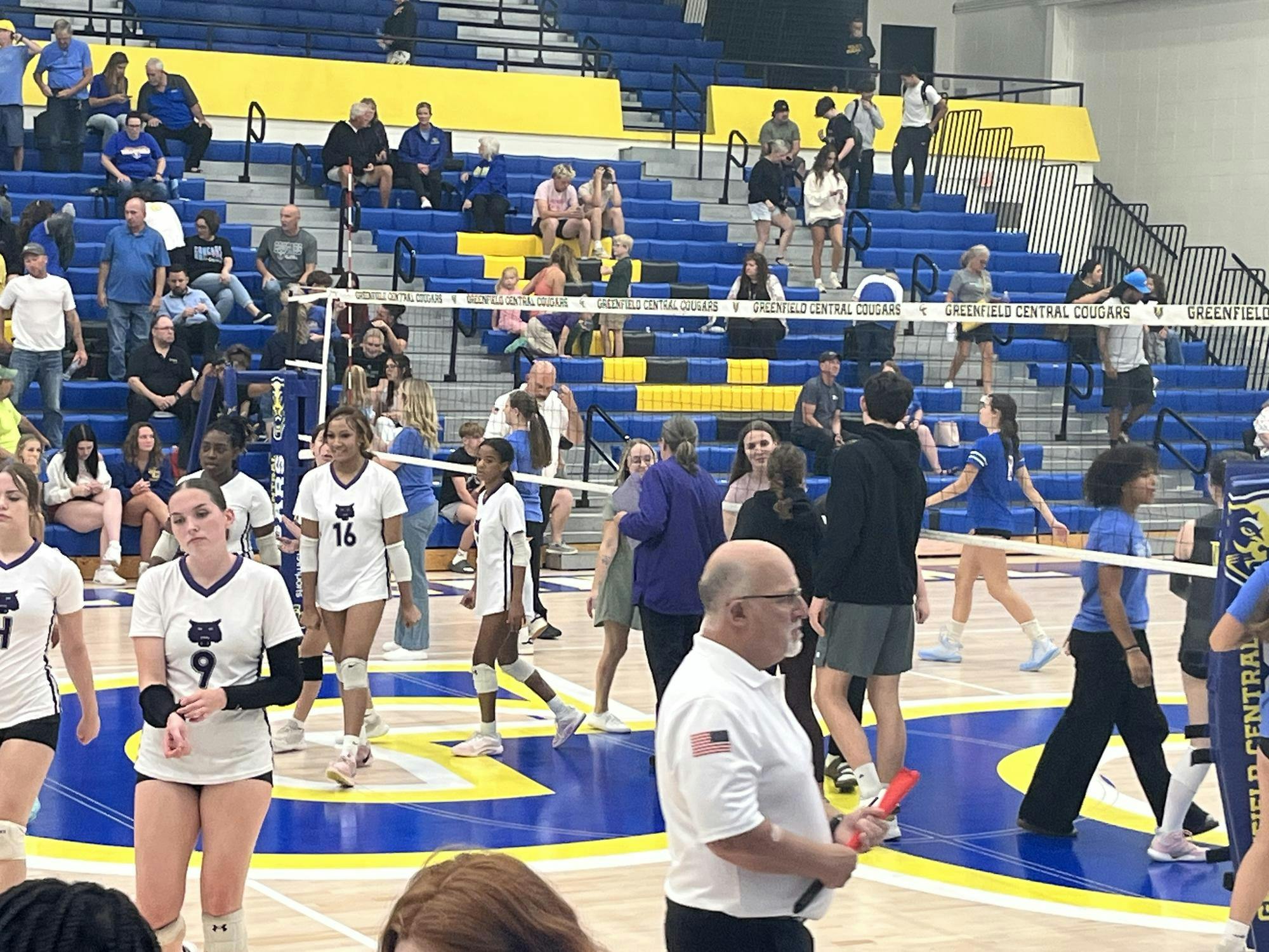 Muncie Central girls volleyball coach Kate Hughes delivers handshakes to the winning Lady Cougars. The Lady Bearcats lost all three sets in the match. Photo by Evan Shotts.
