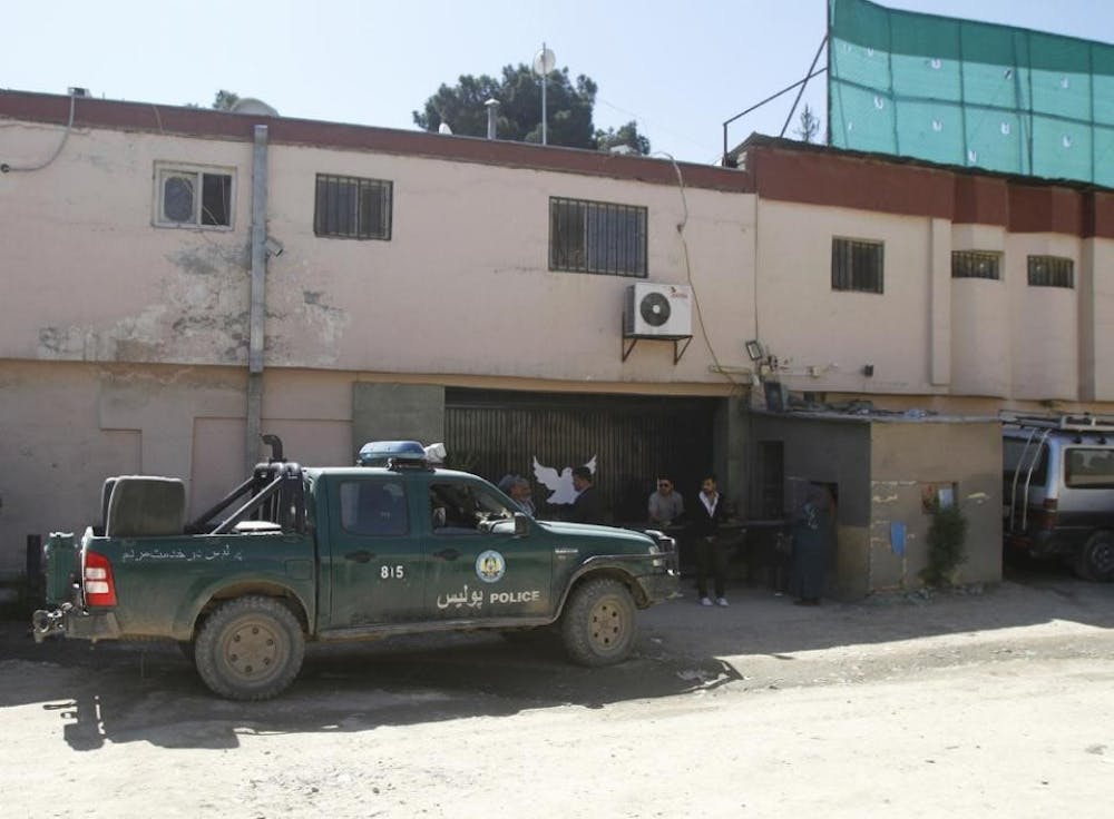 Afghan police stand guard outside Park Palace guesthouse Thursday, May 14, 2015 after being attacked by gunmen in Kabul, Afghanistan. Gunmen stormed the guesthouse as it hosted a party for foreigners, and authorities said five people, including an American, were killed during an hourslong siege that ended early Thursday morning. (AP Photo/Allauddin Khan)