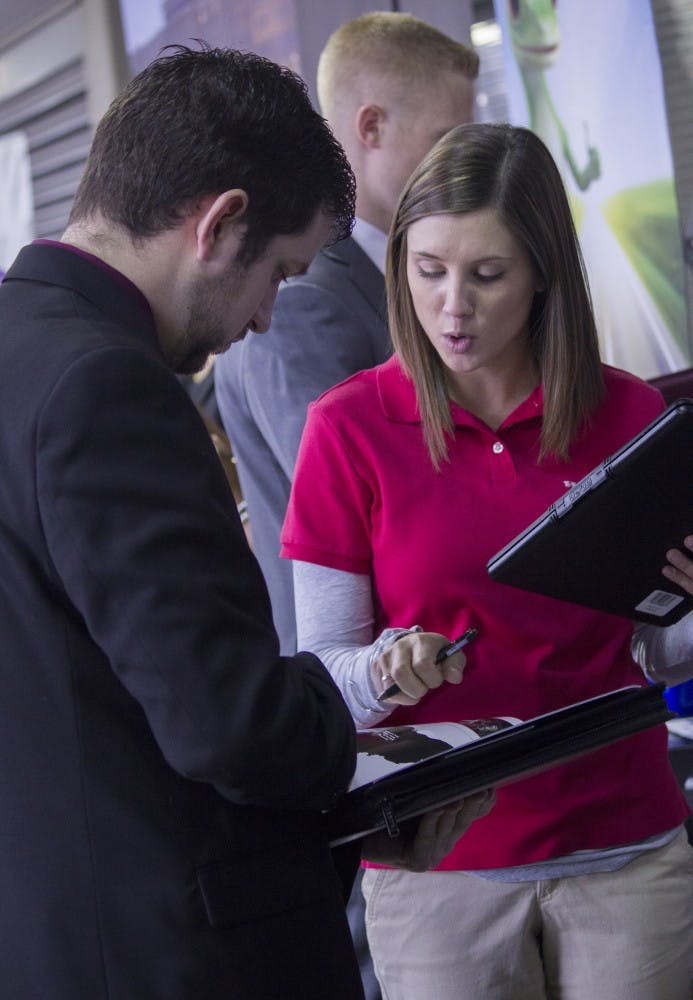 A student talks to a business representative during the Cardinal Job Fair on Feb. 11 at Worthen Arena. DN PHOTO JESSICA LYLE