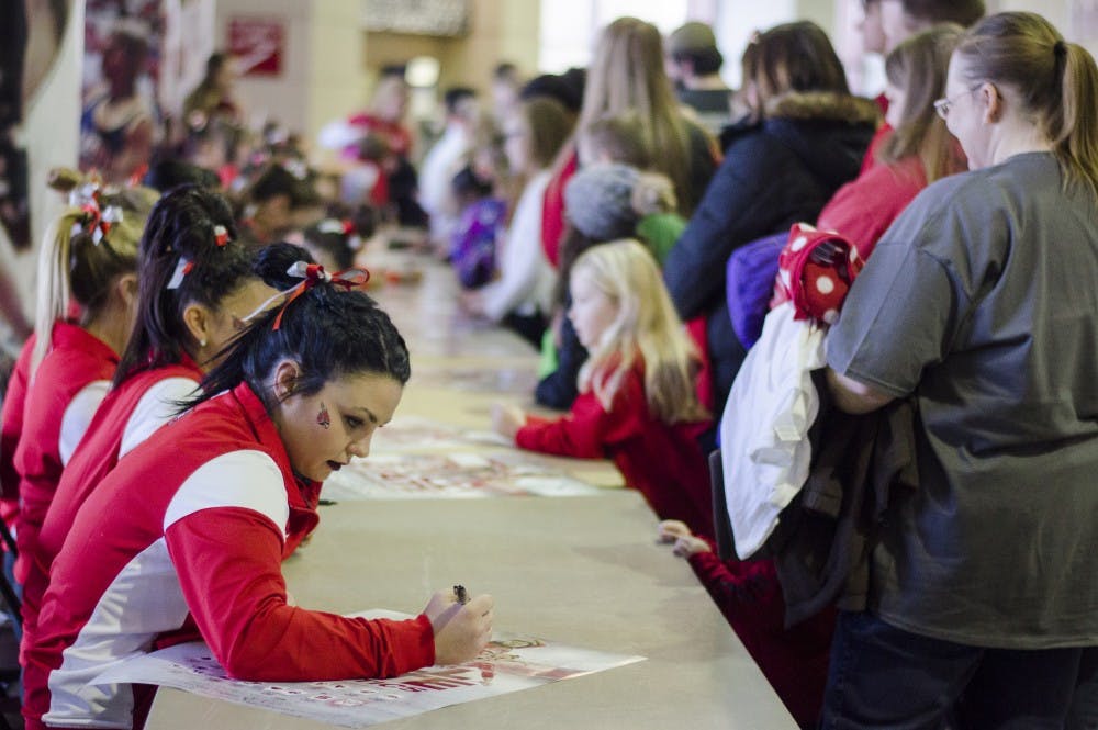 <p>The Ball State Gymnastics team signs posters for fans after their meet against Eastern Michigan and Illinois State on Jan. 24 in Worthen Arena. DN PHOTO BREANNA DAUGHERTY</p>