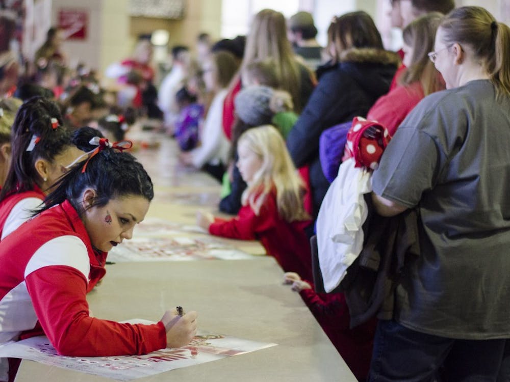 The Ball State Gymnastics team signs posters for fans after their meet against Eastern Michigan and Illinois State on Jan. 24 in Worthen Arena. DN PHOTO BREANNA DAUGHERTY