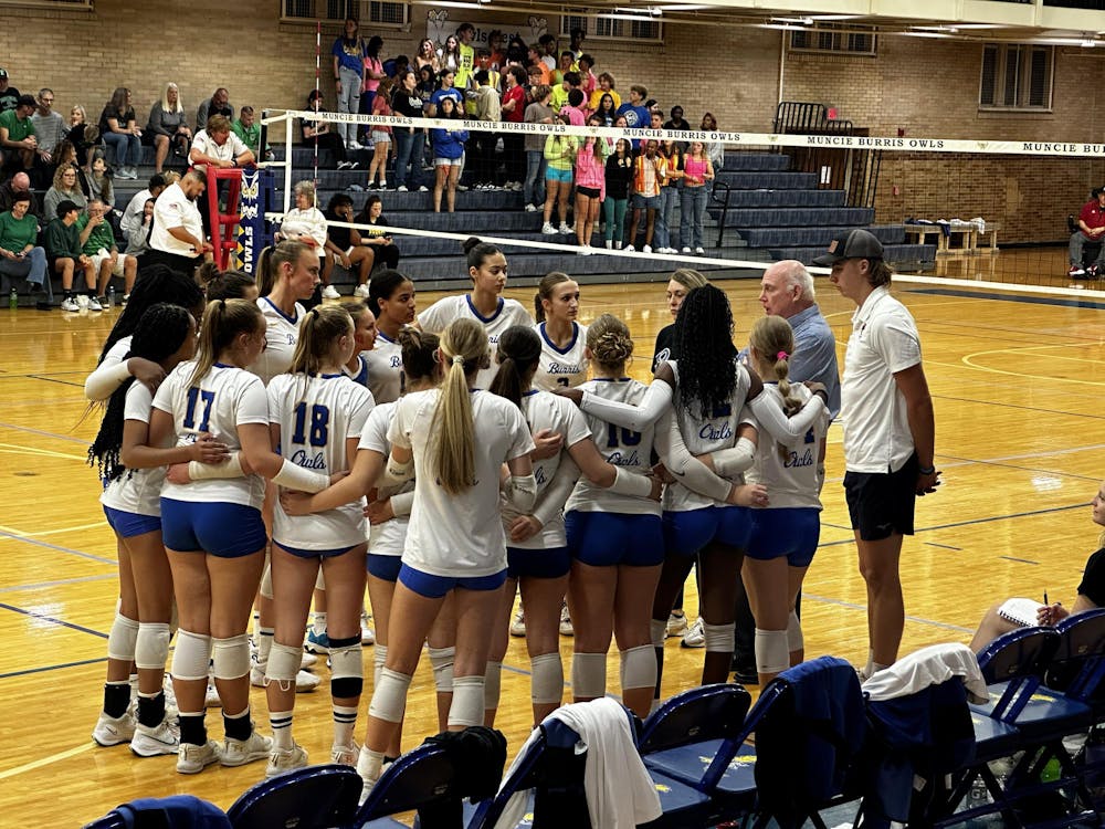 <p>Head coach Jim Craig (right, blue shirt) calls a timeout during the first set after Yorktown Tigers takes an early lead during over the Muncie Burris Owls in the Indy Ignite high school match of the week Oct. 12. The Tigers swept the Owls 3-0. Burris won sectionals at Wapahani the next week. Derran Cobb, BSU</p>