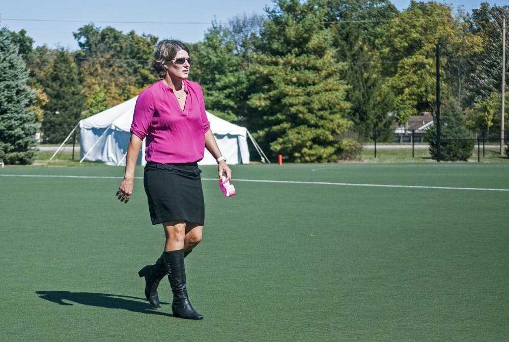Ball State field hockey coach Sally Northcroft walks off the field during halftime of the "Think Pink" game against Bellarmine University. Though Northcroft's Cardinals have struggled so far this season, they came alive to beat Bellarmine, 7-1. DN PHOTO COLIN GRYLLS