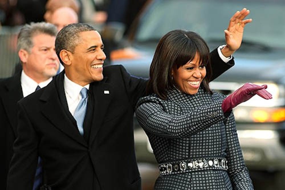 President Barack Obama and first lady Michelle Obama wave at the crowd as the inaugural parade makes it way to the White House on Monday, January 21, 2013 in Washington, D.C. The president was sworn in for a second term on Monday. MCT PHOTO