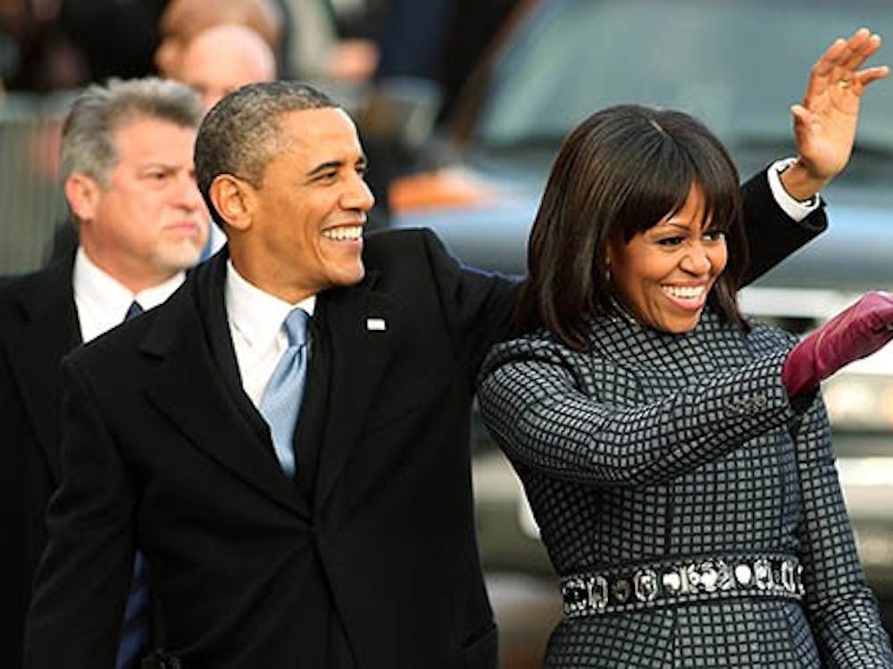 President Barack Obama and first lady Michelle Obama wave at the crowd as the inaugural parade makes it way to the White House on Monday, January 21, 2013 in Washington, D.C. The president was sworn in for a second term on Monday. MCT PHOTO