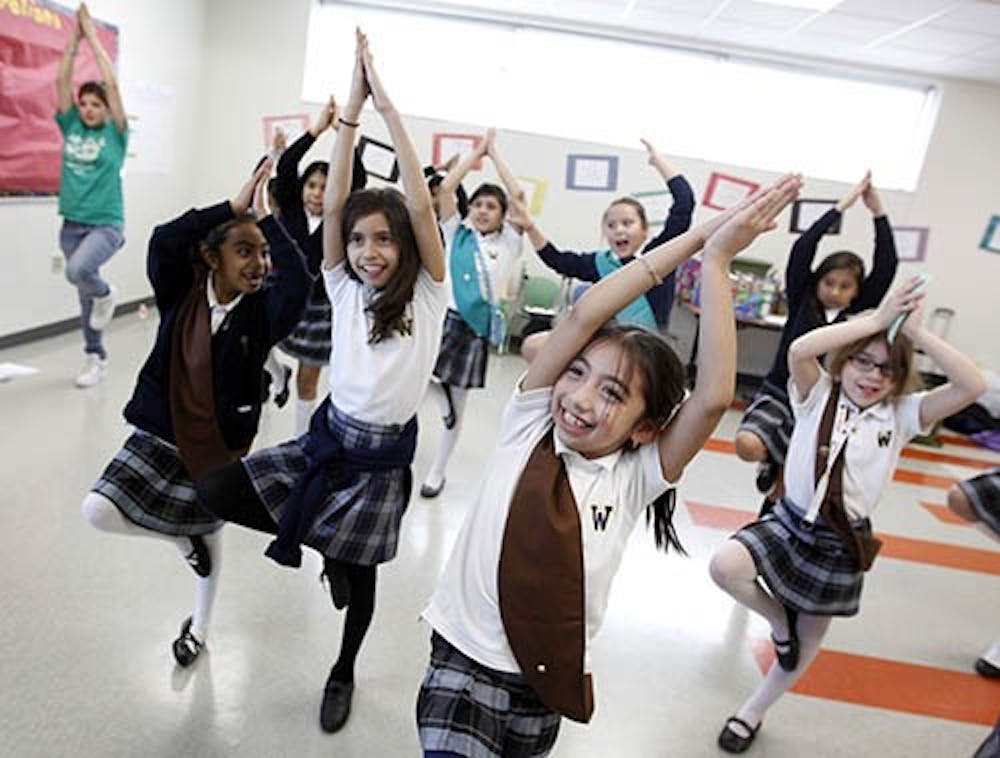 Girl Scouts participate in a yoga session during a meeting in Texas. The century-old organization is struggling finically after numerous employees were allowed to retire early, leaving a large deficit in pension plans. MCT PHOTO