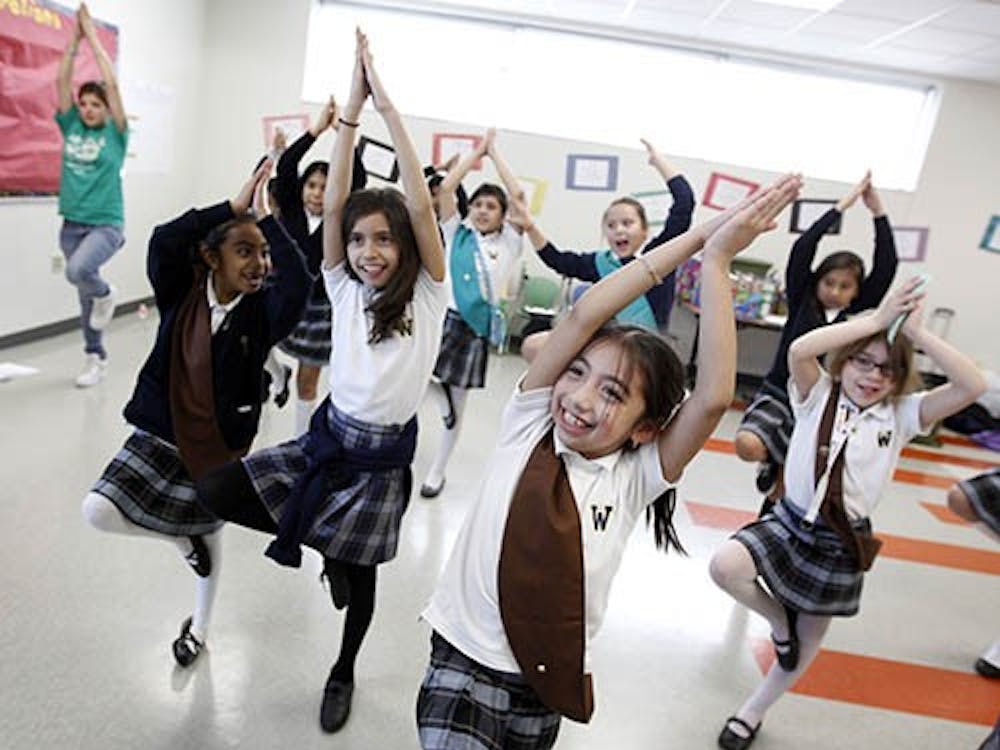Girl Scouts participate in a yoga session during a meeting in Texas. The century-old organization is struggling finically after numerous employees were allowed to retire early, leaving a large deficit in pension plans. MCT PHOTO