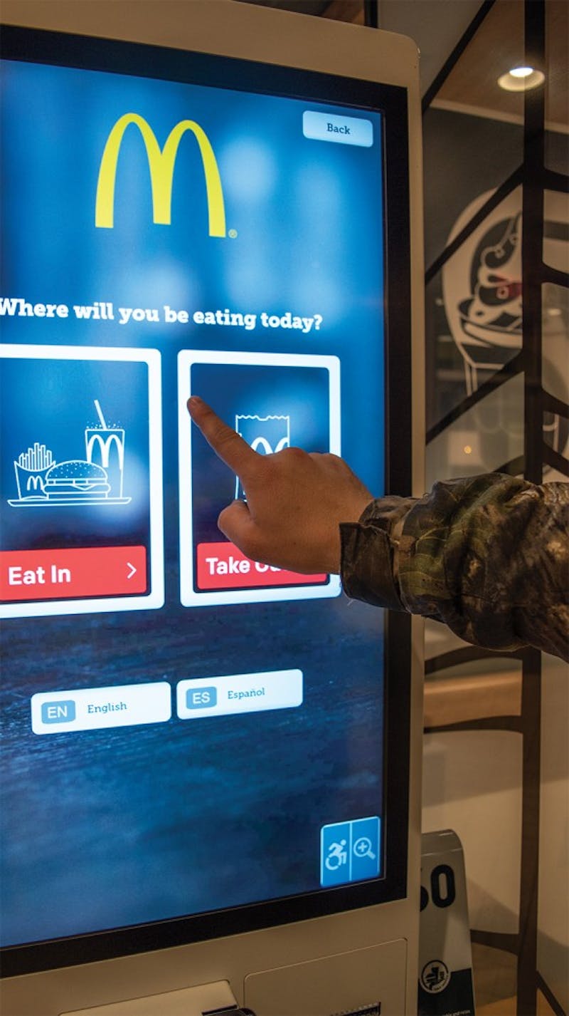 Local resident touches the LCD screen at a McDonald's Monday, Feb. 3. Robots are predicted to be implemented more often in the service industry. Stephanie Amador, DN