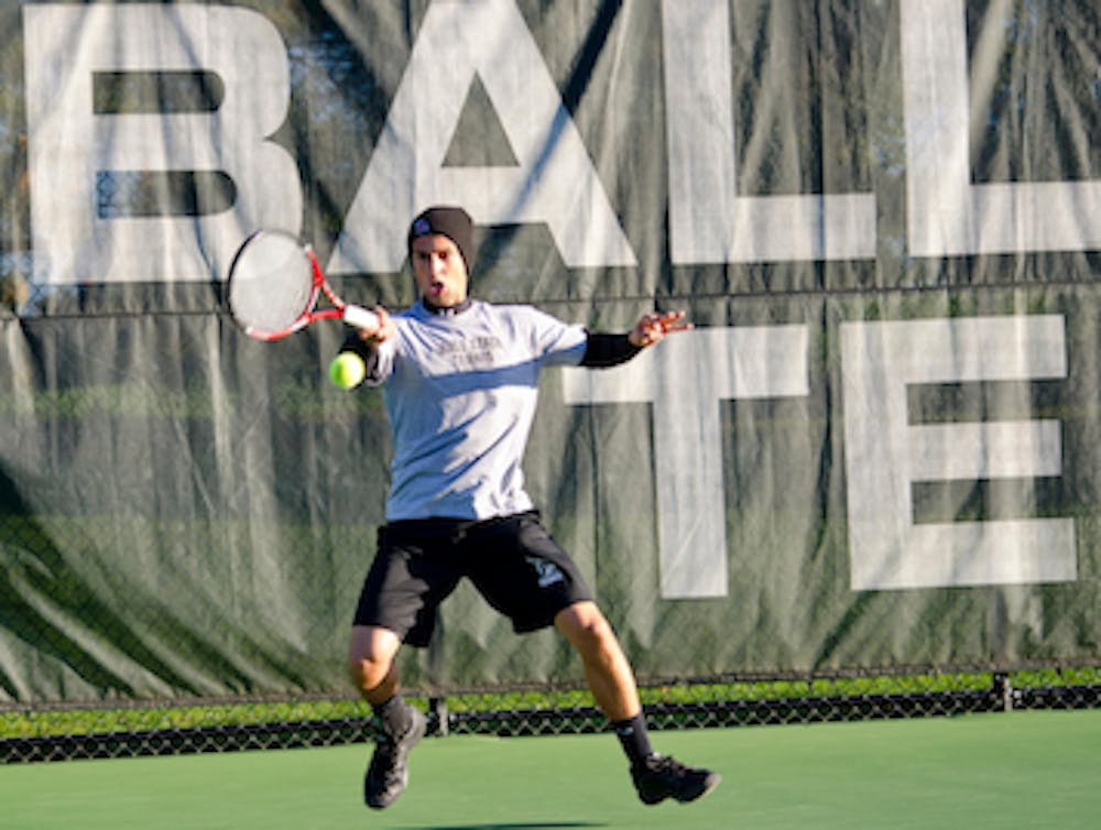 DN FILE PHOTO COREY OHLENKAMP Austin Smith connects on a forehand shot during the Ball State Invitational last year. The men's tennis team will participate in the Texas University invitational this weekend. 