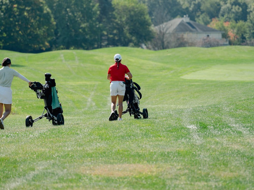 Graduate student Peyton Broce wheels her golf bag on the course during the Cardinal Classic at The Players Club Sept. 20. Broce scored 79 at the tournament. Eli Pierson, DN