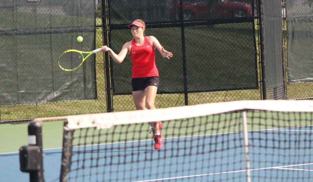 Junior Rebecca Herrington attempts to return the ball against a Detroit Mercy player in the first day of the Hidden Dual tournament. Herrington won this singles match, 6-2, 6-1. Patrick Murphy,DN