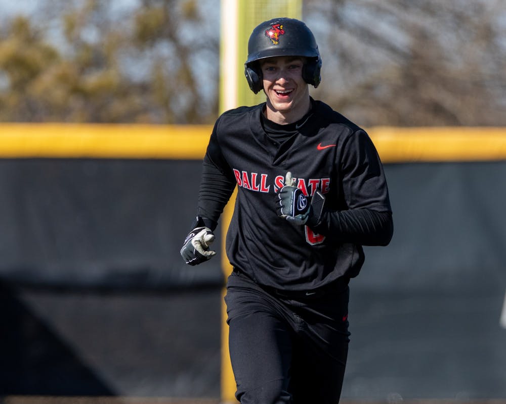 Junior outfeilder Zach Cole smiles while running home after senior teammate Justin Conant hit a home run during the bottom of the seventh inning in the second game of Ball State's doubleheader against Eastern Michigan Mar. 14 at First Merchants Ballpark Complex. Conant's home was the final score of the game for the Cardinals, advancing their lead to 11-7 over Eastern Michigan. Eli Houser, DN