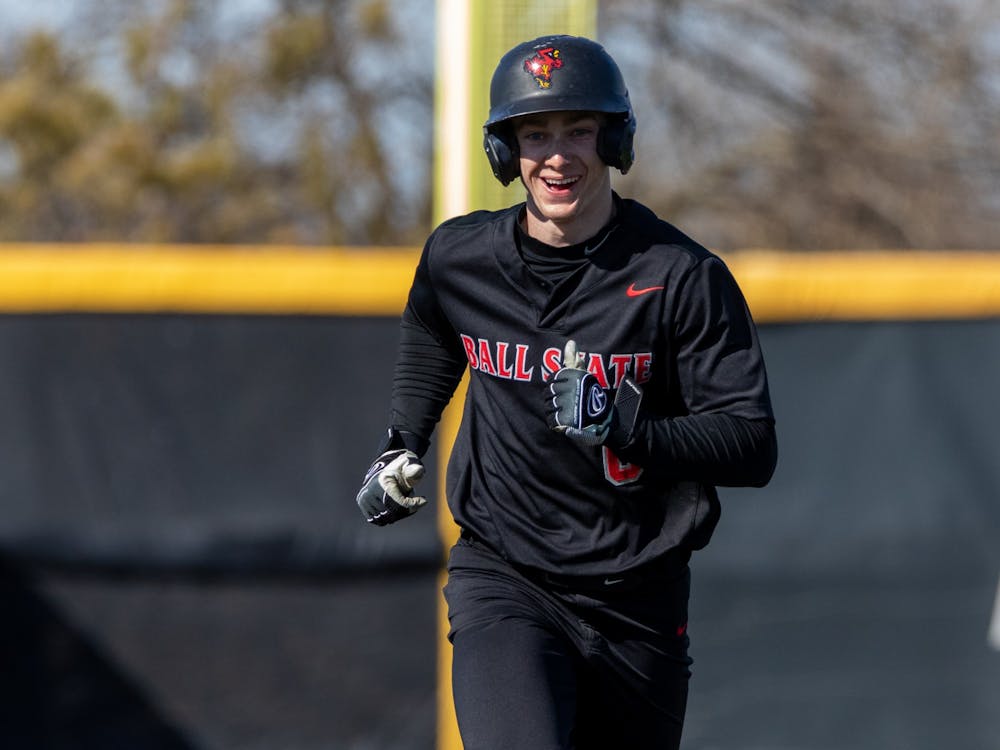 Junior outfeilder Zach Cole smiles while running home after senior teammate Justin Conant hit a home run during the bottom of the seventh inning in the second game of Ball State's doubleheader against Eastern Michigan Mar. 14 at First Merchants Ballpark Complex. Conant's home was the final score of the game for the Cardinals, advancing their lead to 11-7 over Eastern Michigan. Eli Houser, DN
