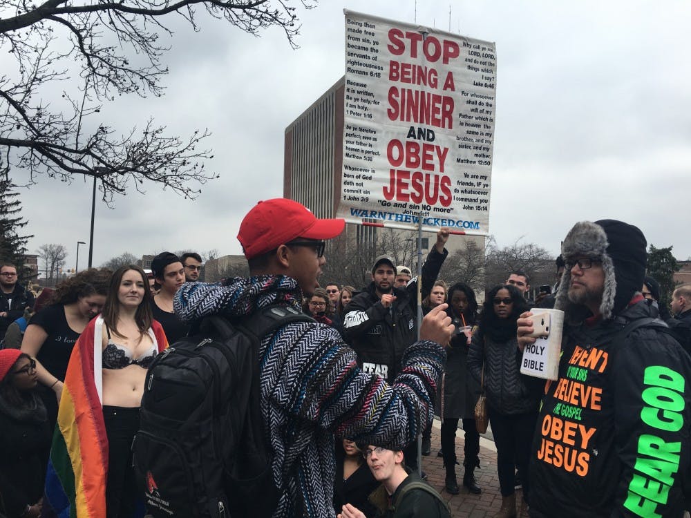 <p>A preacher was speaking on campus about homosexuality and sodomy, angering some students. DN PHOTO MEGAN MELTON</p>