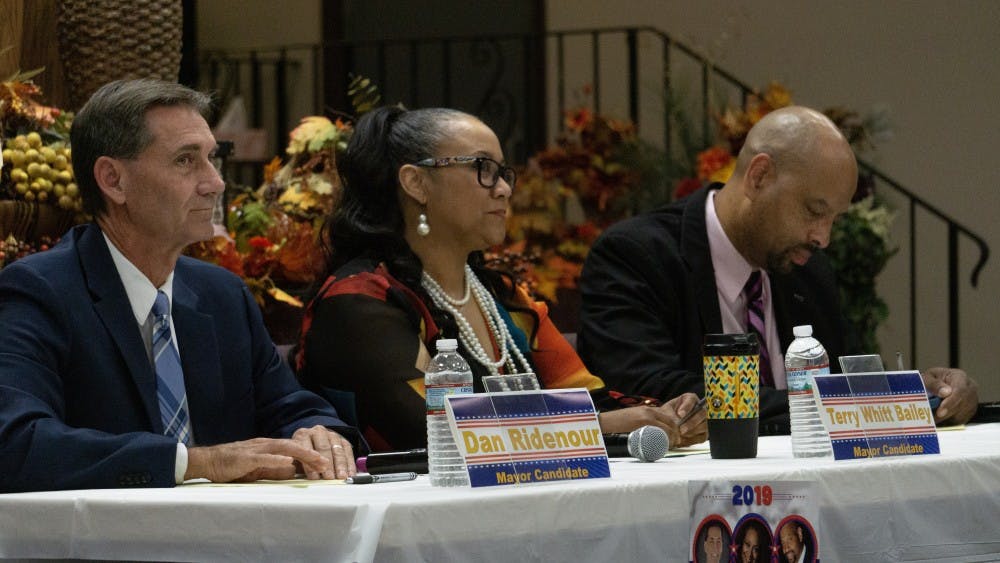 Dan Ridenour (R), Terry Whitt Bailey (D) and Steve Smith (L) wait for the forum to begin. The forum, hosted by the NAACP at Church of the Living God, touched on questions concerning the city’s rental codes, corruption and the racial disparities within Muncie’s police and fire departments. John Lynch, DN