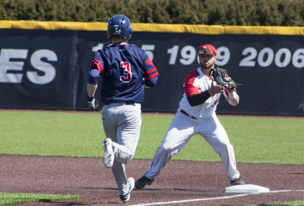 <p>Ball State baseball player John Ricotta, 31, tags the base as Dayton player Connor Echols, 3, runs to first base during the game against the University of Dayton on March 18 at the Baseball Diamond at First Merchant’s Ballpark Complex. Echols was called out. <strong>Briana Hale, DN</strong></p>