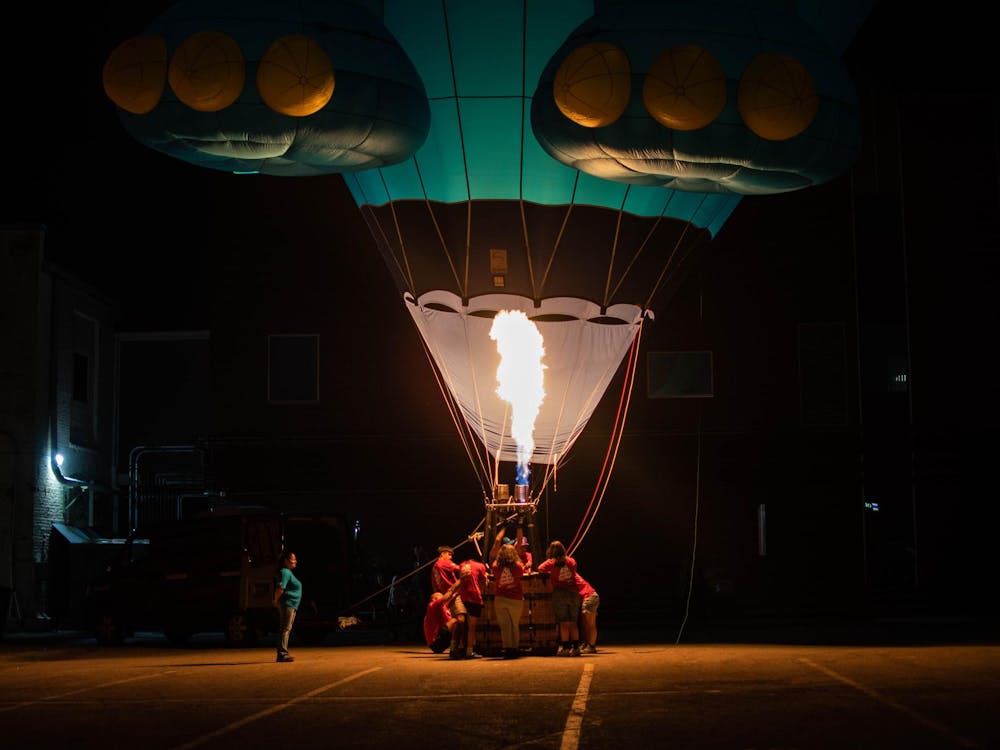 A hot air balloon Glow Show lights up the area during Fire Up Muncie in downtown Muncie, Aug. 2. Featured balloons included Finley the Fish, sponsored by 3Rivers Federal Credit Union; Boo the Ghost, sponsored by MDDP; and vampire balloon Lil D, sponsored by Woof Boom Radio. Kylee White, DN