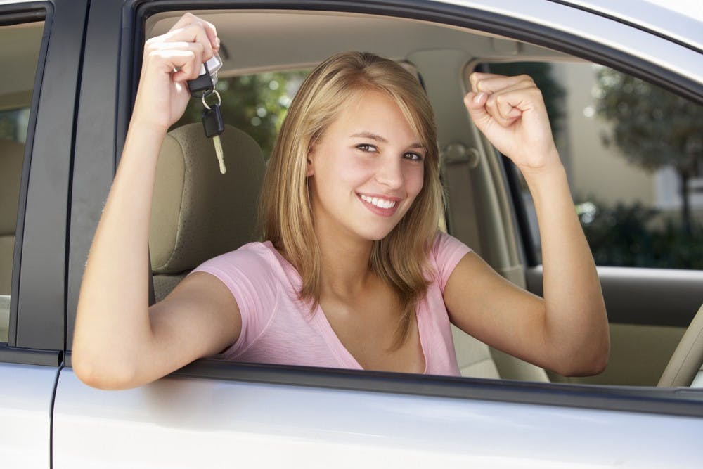 Teenage Girl Celebrating Owning First Car